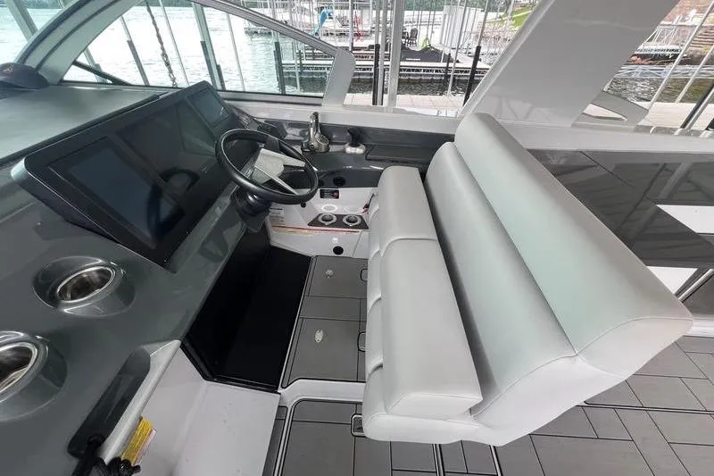 Slide: The Image of 2023 Aviara 36 boat interior with modern helm, steering wheel, and comfortable seating. - 11