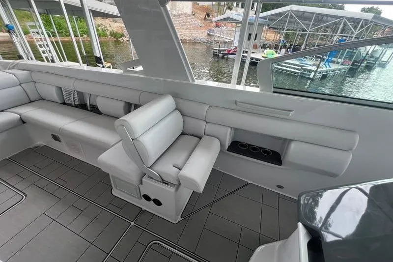 Slide: The Image of 2023 Aviara 36 boat interior with sleek seating and waterfront view. - 12