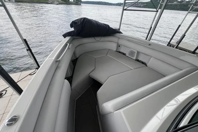 Slide: The Image of 2023 Aviara 36 boat interior with sleek seating, docked by a scenic lake. - 13