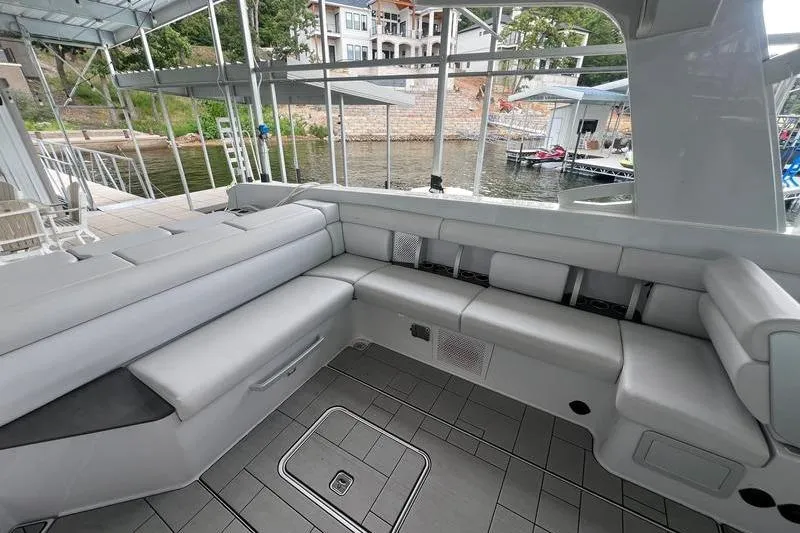 Slide: The Image of Luxurious seating area on 2023 Aviara 36 boat docked by the waterfront. - 4