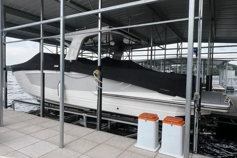 Slide: The Image of 2023 Aviara 36 boat docked under a covered marina. - 5