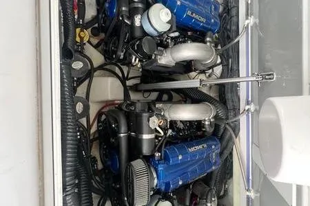 Slide: The Image of 2023 Aviara 36 boat engine compartment with dual blue engines. - 8