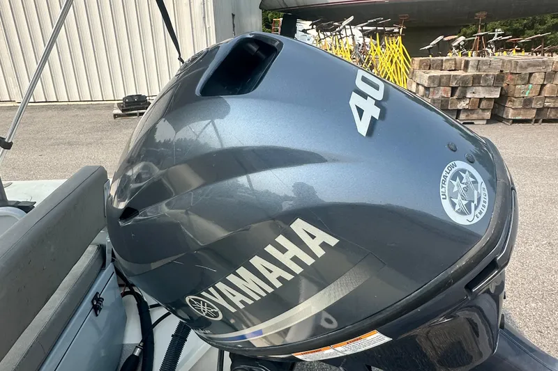 Slide: The Image of Yamaha 40HP outboard motor on 2016 Highfield RS-460 boat, parked outdoors. - 10