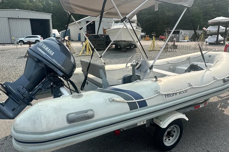 Slide: The Image of 2016 Highfield RS-460 inflatable boat with Yamaha outboard motor on a trailer. - 2