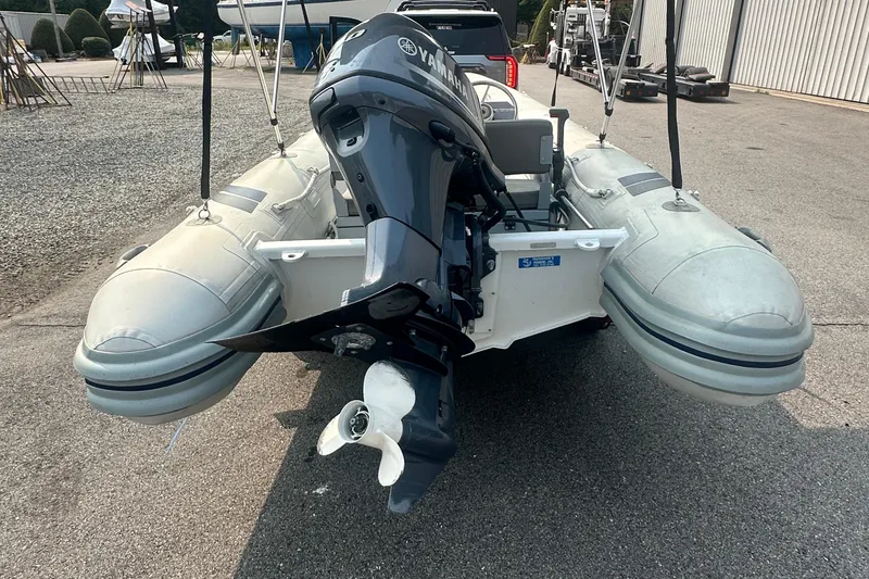 Slide: The Image of 2016 Highfield RS-460 inflatable boat with Yamaha outboard motor, parked on a trailer. - 3