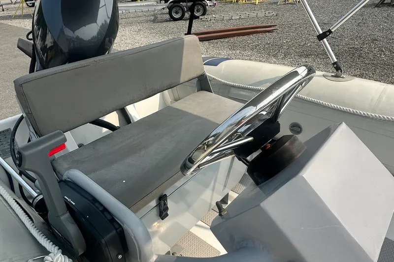 Slide: The Image of 2016 Highfield RS-460 boat interior with steering wheel and seating. - 4