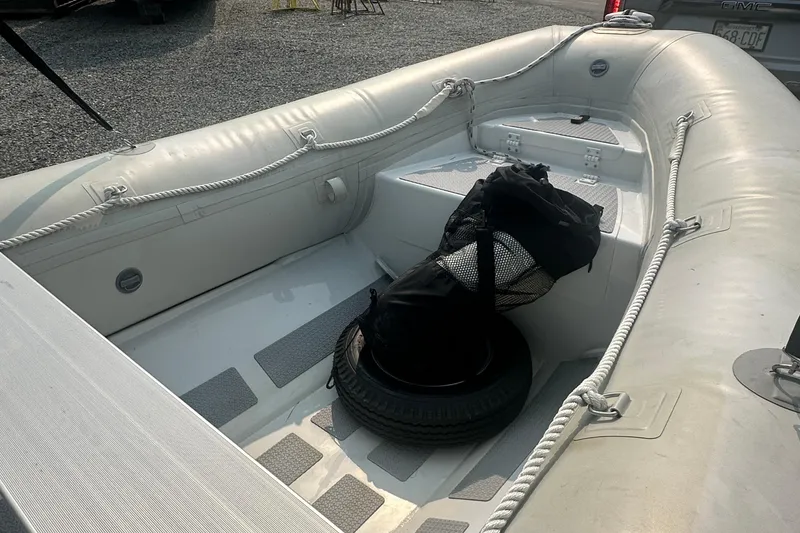 Slide: The Image of 2016 Highfield RS-460 inflatable boat interior with ropes and a spare tire. - 5
