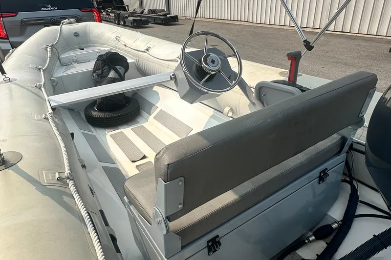 Slide: The Image of 2016 Highfield RS-460 inflatable boat interior with steering wheel and seating. - 7
