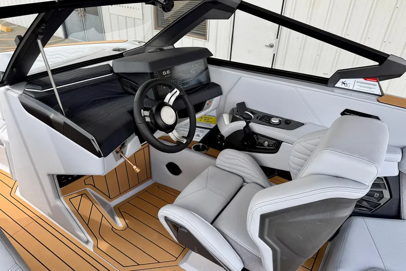 Slide: The Image of 2026 Nautique Super Air Nautique G23 boat interior with modern helm and luxurious seating. - 13