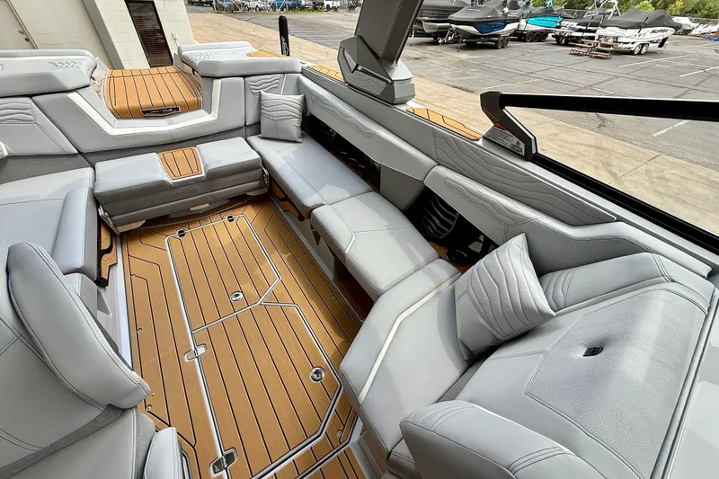 Slide: The Image of 2026 Nautique Super Air Nautique G23 interior with luxurious seating and teak flooring. - 15