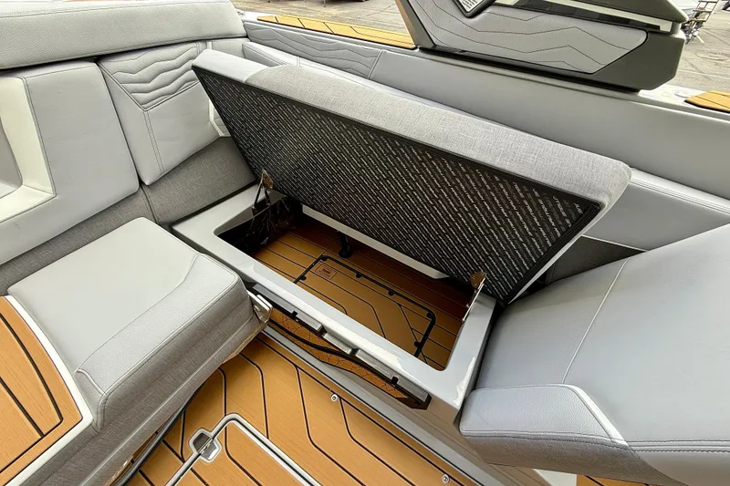 Slide: The Image of 2026 Nautique Super Air Nautique G23 interior storage compartment with sleek seating design. - 18