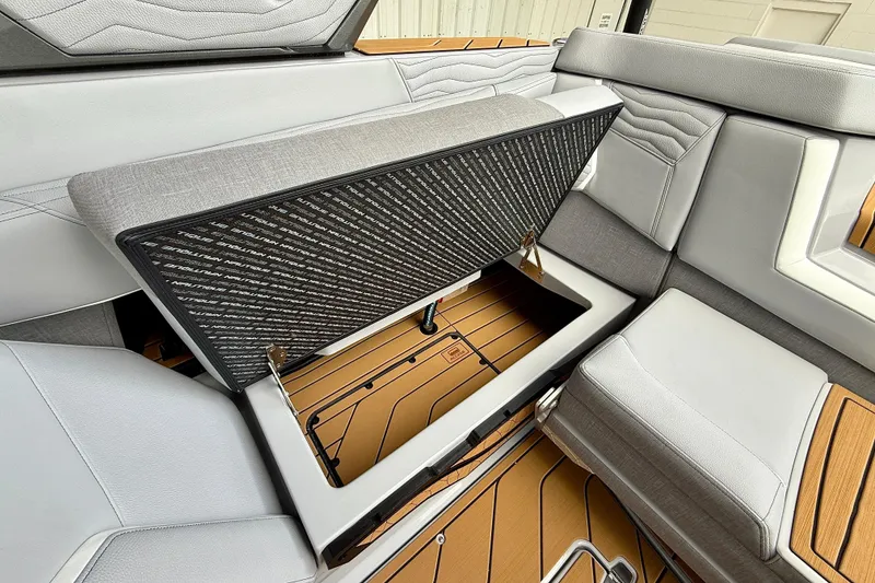 Slide: The Image of 2026 Nautique Super Air Nautique G23 interior storage compartment with sleek upholstery design. - 19