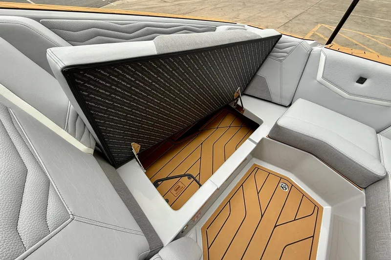 Slide: The Image of 2026 Nautique Super Air Nautique G23 interior storage compartment with cushioned seating. - 25
