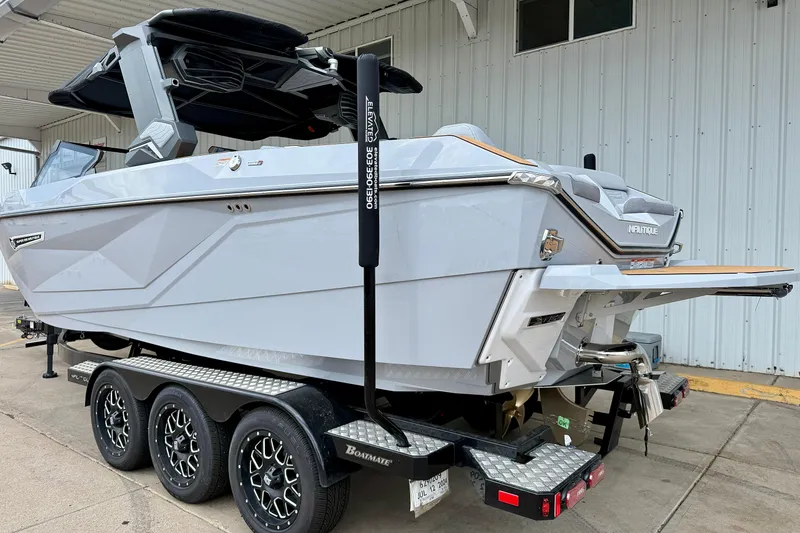 Slide: The Image of 2026 Nautique Super Air Nautique G23 boat on trailer, sleek design, parked outdoors. - 3