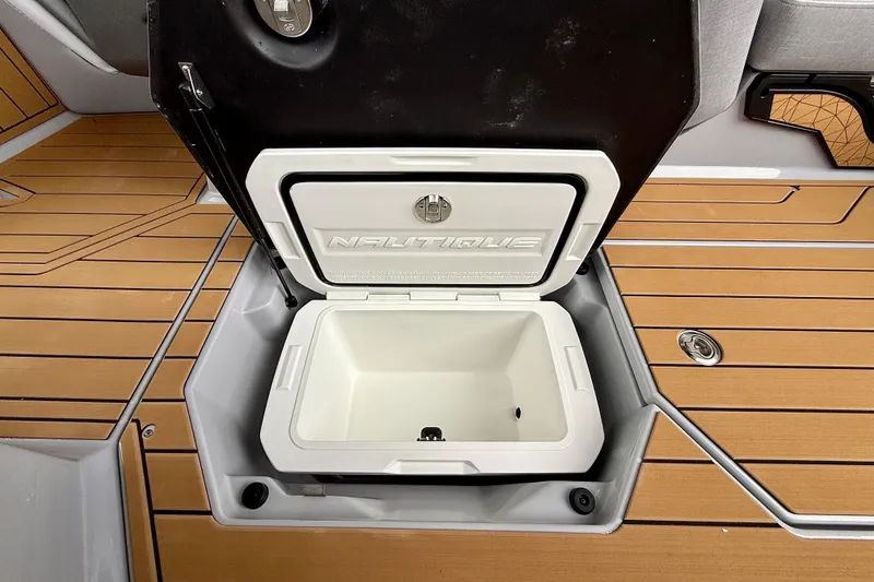 Slide: The Image of 2026 Nautique Super Air Nautique G23 open storage compartment on teak deck. - 38