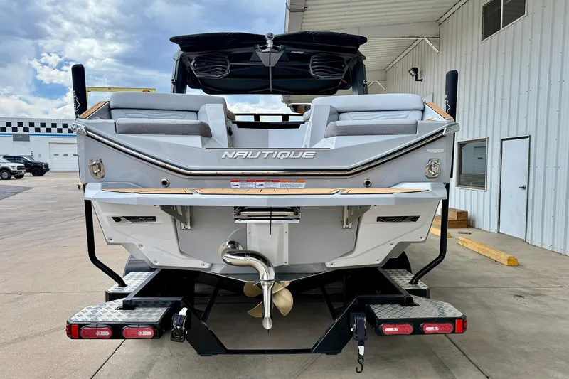 Slide: The Image of 2026 Nautique Super Air Nautique G23 boat rear view at a marina. - 4