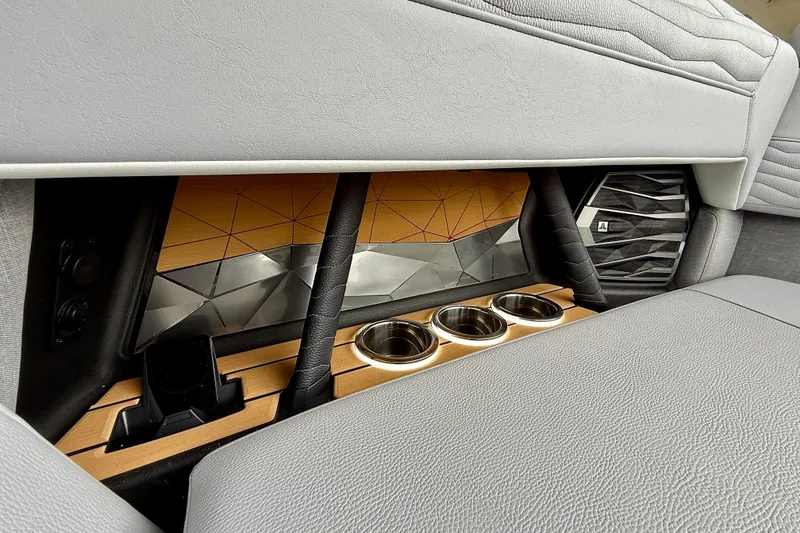 Slide: The Image of 2026 Nautique Super Air Nautique G23 interior with cup holders and speaker detail. - 41