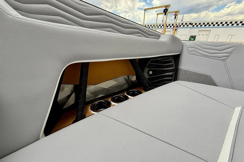 Slide: The Image of 2026 Nautique Super Air Nautique G23 interior with sleek gray upholstery and cup holders. - 42
