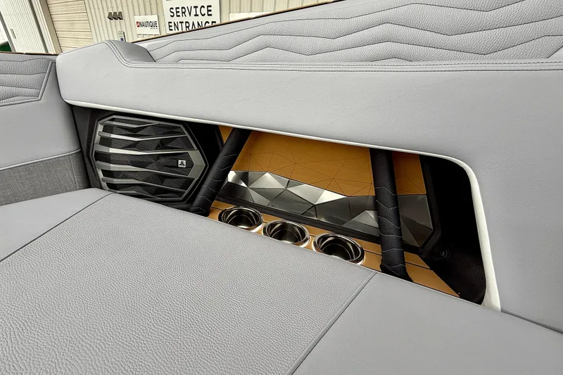 Slide: The Image of 2026 Nautique Super Air Nautique G23 interior with speaker and cup holders. - 43