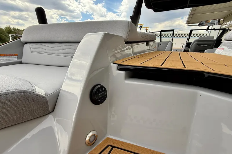 Slide: The Image of 2026 Nautique Super Air Nautique G23 interior with sleek seating and wooden deck. - 48