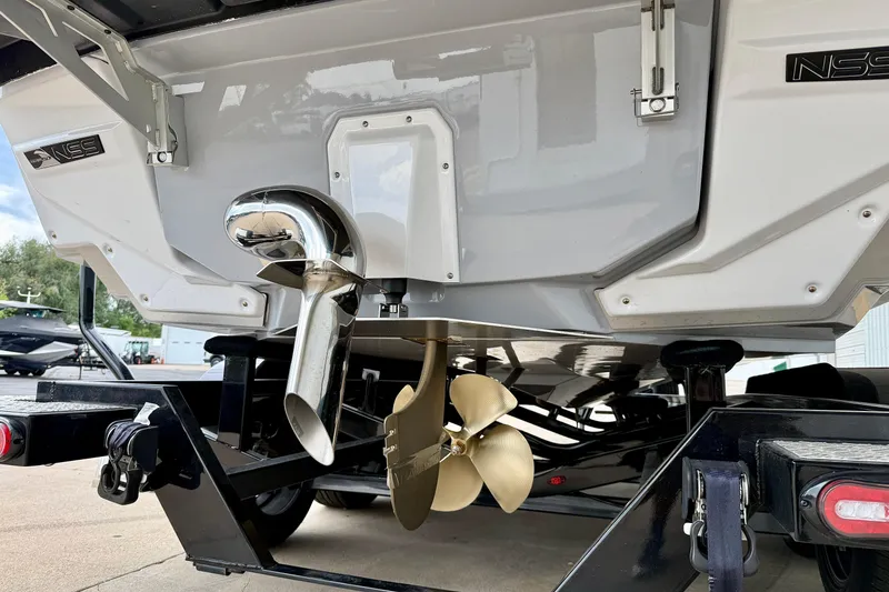 Slide: The Image of 2026 Nautique Super Air Nautique G23 boat propeller and exhaust detail on trailer. - 5