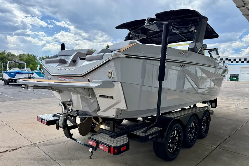 Slide: The Image of 2026 Nautique Super Air Nautique G23 boat on trailer under cloudy sky. - 6
