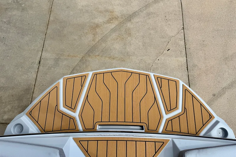 Slide: The Image of 2026 Nautique Super Air Nautique G23 swim platform with teak-style decking. - 9