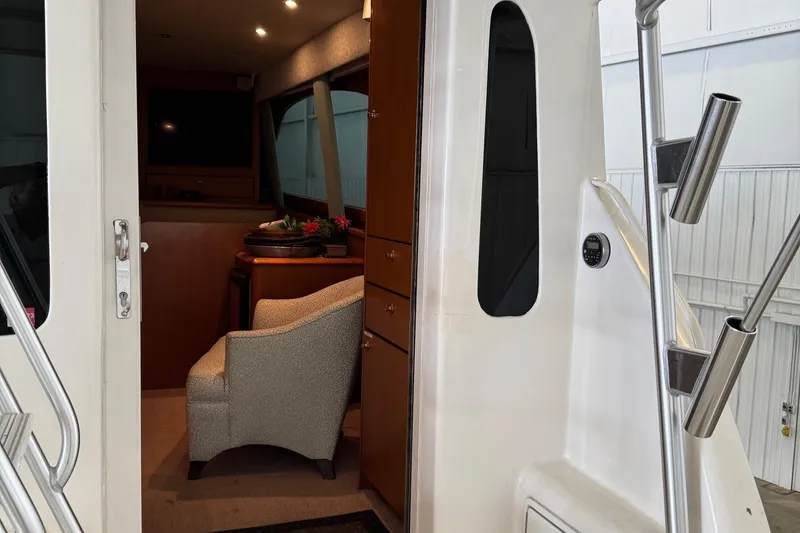 Slide: The Image of Interior view of 2005 Fifth Ocean Yachts 46 SS, featuring elegant seating and cabinetry. - 3