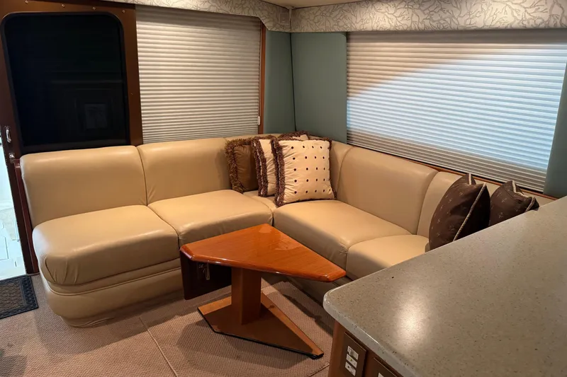 Slide: The Image of Luxurious interior of 2005 Fifth Ocean Yachts 46 SS with beige leather seating and decorative pillows. - 5