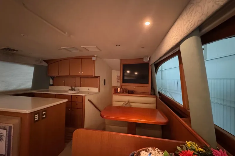 Slide: The Image of Luxurious interior of 2005 Fifth Ocean Yachts 46 SS with kitchen and dining area. - 10