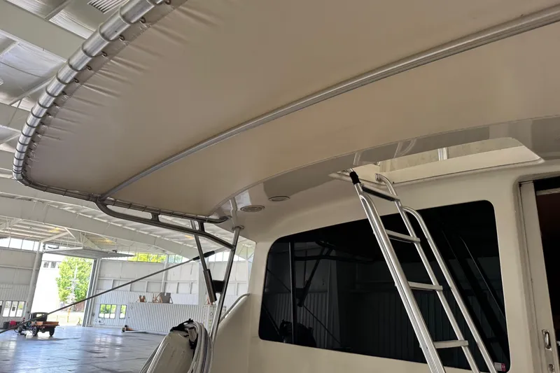 Slide: The Image of 2005 Fifth Ocean Yachts 46 SS with ladder and canopy in a spacious indoor setting. - 2