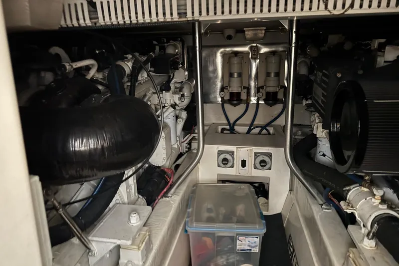 Slide: The Image of Engine room of 2005 Fifth Ocean Yachts 46 SS, showcasing mechanical components and storage. - 4