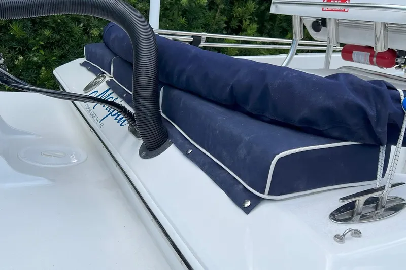 Slide: The Image of 2022 Paramount 21 boat with blue cushions and safety equipment on deck. - 5
