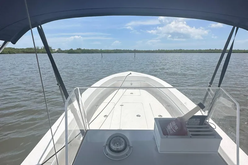 Slide: The Image of 2022 Paramount 21 boat on calm water under blue sky. - 6