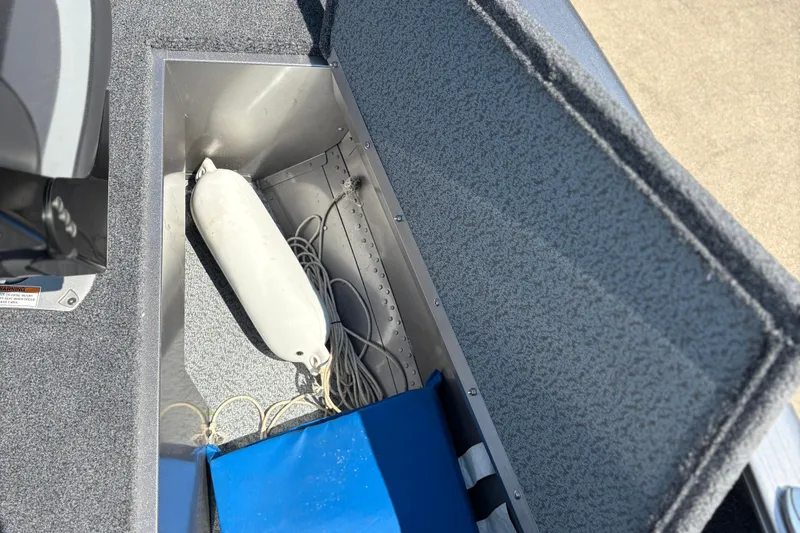 Slide: The Image of Open storage compartment in 2020 Lund 1775 Adventure SS boat with fender and cables. - 12