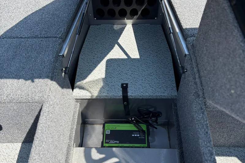 Slide: The Image of 2020 Lund 1775 Adventure SS boat interior storage compartment with battery charger. - 13