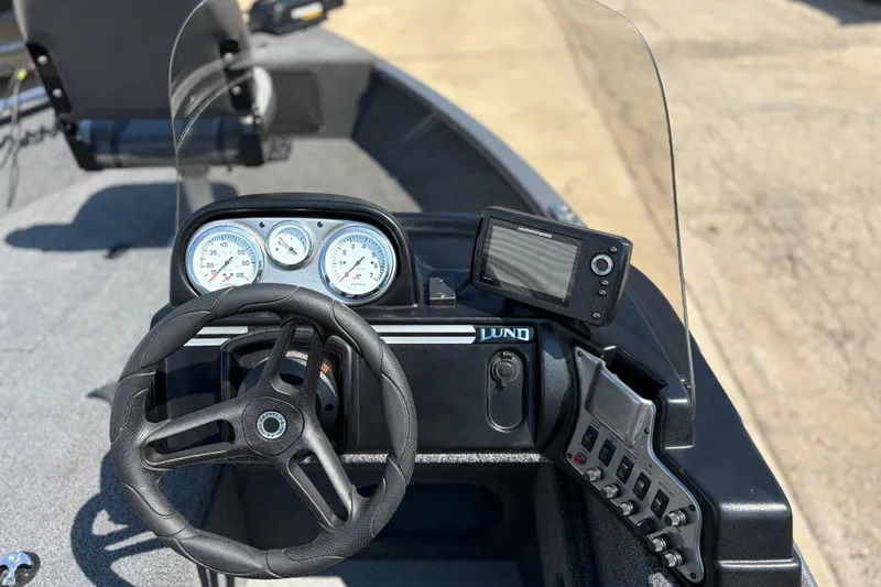 Slide: The Image of 2020 Lund 1775 Adventure SS boat dashboard with steering wheel and gauges. - 15