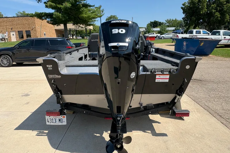 Slide: The Image of 2020 Lund 1775 Adventure SS boat with Mercury 90 engine, parked outdoors. - 2