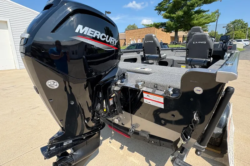 Slide: The Image of 2020 Lund 1775 Adventure SS boat with Mercury outboard motor, parked outdoors. - 23