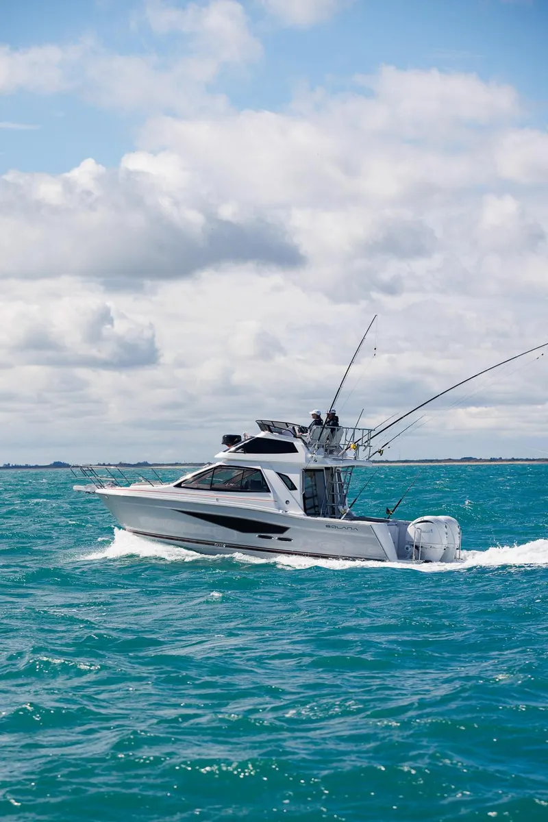 The Image of Solara S-310 SB 2026 boat cruising on turquoise ocean under cloudy sky. - 0