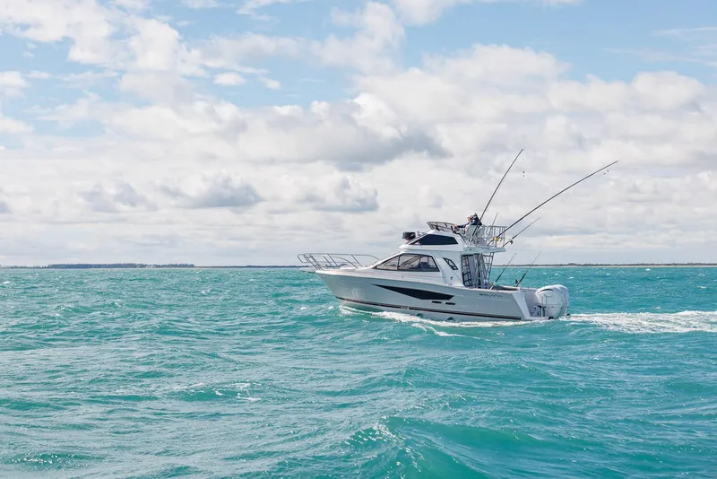 Slide: The Image of 2026 Solara S-310 SB boat cruising on turquoise ocean under cloudy sky. - 1