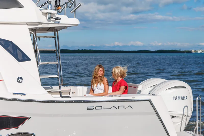 Slide: The Image of Two people enjoying a ride on a 2026 Solara S-310 SB boat. - 10
