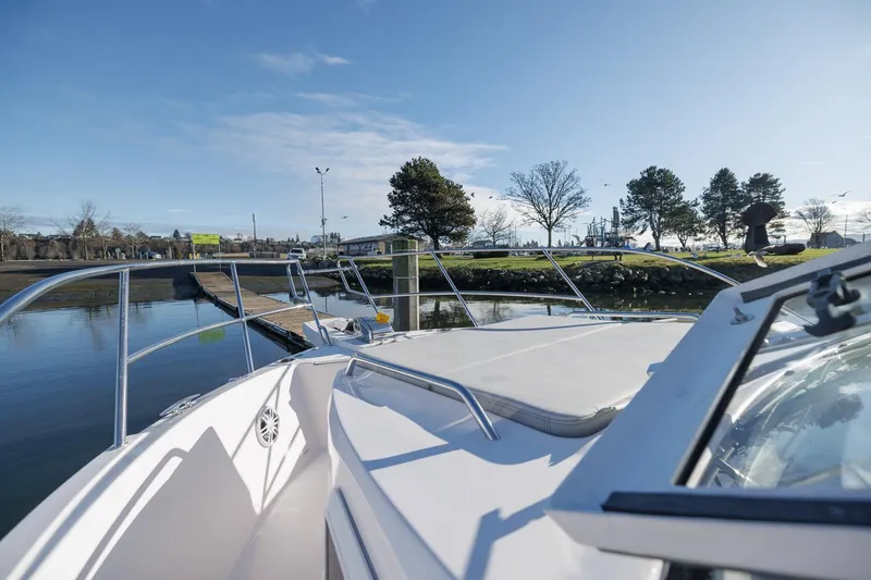 Slide: The Image of 2026 Solara S-310 SB boat docked near a scenic waterfront park. - 14