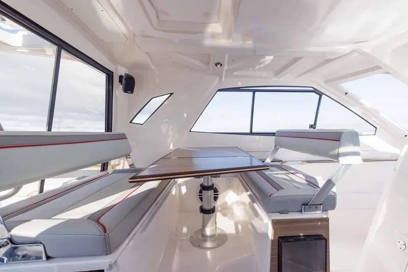 Slide: The Image of Interior of 2026 Solara S-310 SB boat with modern seating and table. - 32