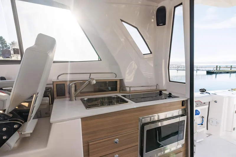 Slide: The Image of Modern kitchen area on 2026 Solara S-310 SB boat with sink and stove. - 36