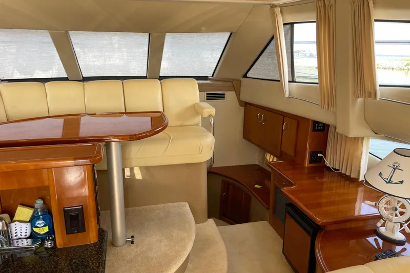 Slide: The Image of Luxurious interior of 2003 Carver 36 Sport Sedan with elegant seating and wooden finishes. - 10