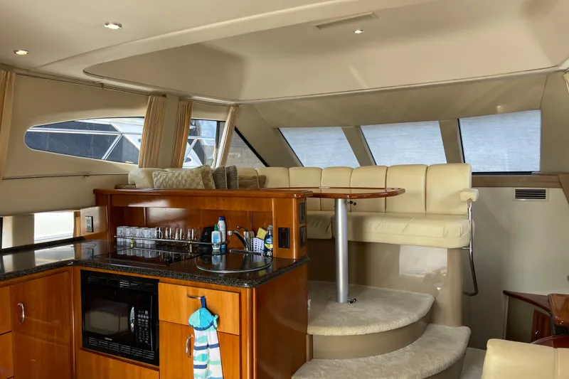 Slide: The Image of Interior of 2003 Carver 36 Sport Sedan yacht with kitchen and seating area. - 11