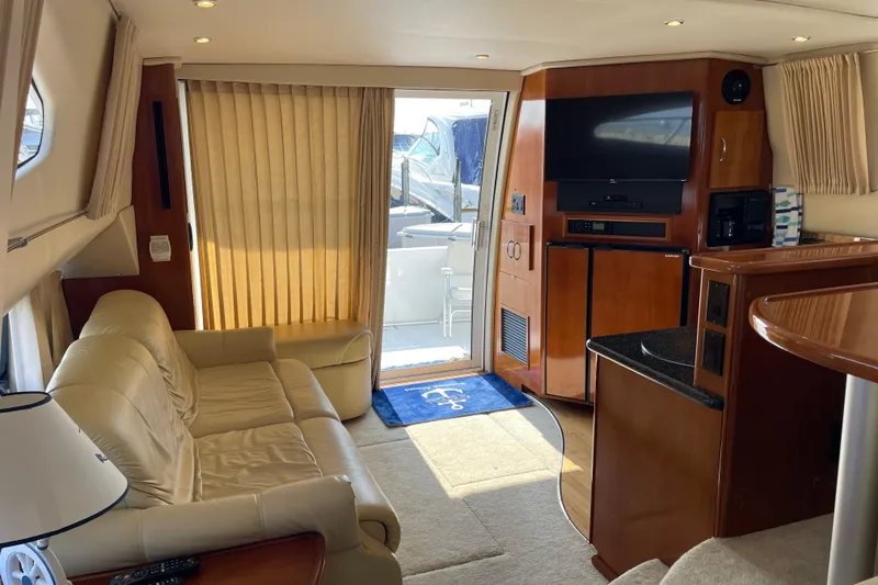 Slide: The Image of Interior of 2003 Carver 36 Sport Sedan yacht with beige sofa and entertainment center. - 13
