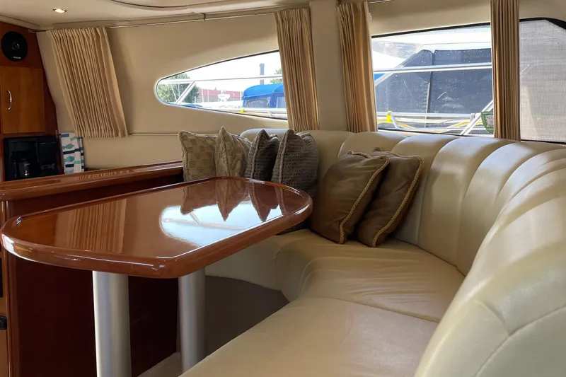 Slide: The Image of Luxurious interior of 2003 Carver 36 Sport Sedan with plush seating and elegant table. - 14