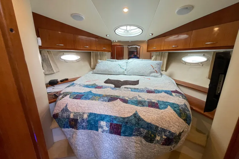 Slide: The Image of Luxurious cabin interior of 2003 Carver 36 Sport Sedan with cozy bed and wooden cabinets. - 16